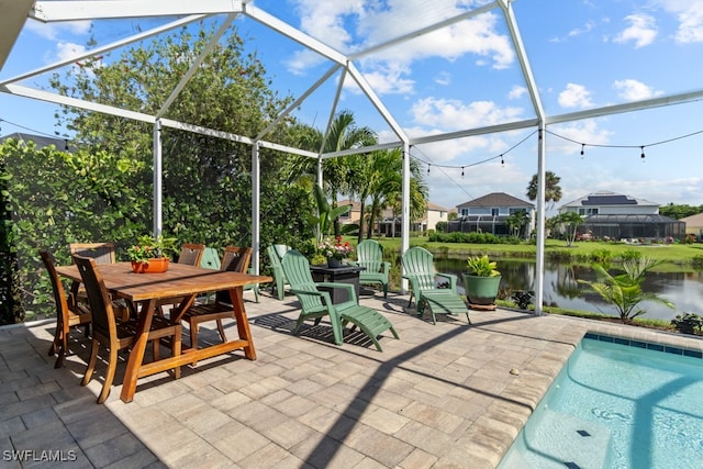 view of patio / terrace with a water view and glass enclosure