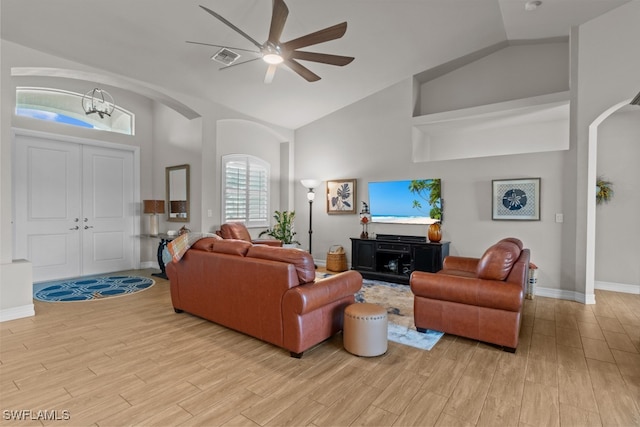 living room featuring high vaulted ceiling, ceiling fan, and light hardwood / wood-style floors