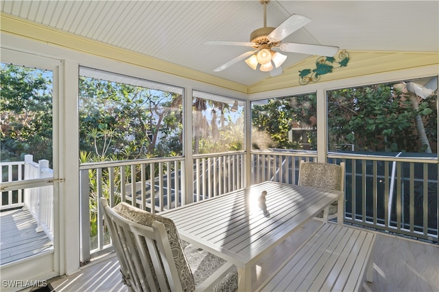 sunroom with ceiling fan and lofted ceiling