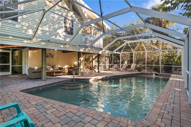 view of pool featuring an outdoor living space, a lanai, and a patio area