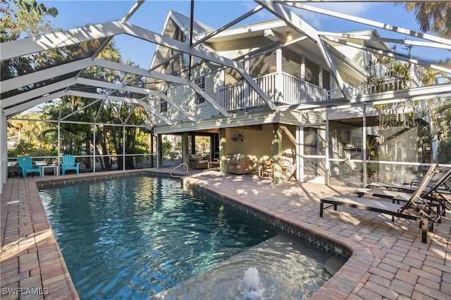 view of swimming pool with a lanai and a patio area