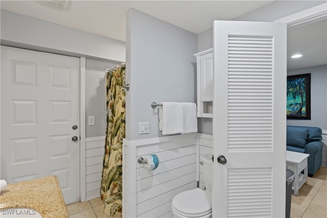 bathroom with tile patterned flooring, vanity, and toilet