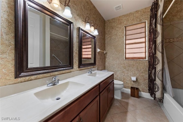 full bathroom featuring tile patterned flooring, vanity, shower / bath combo, and toilet