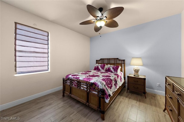 bedroom featuring light hardwood / wood-style flooring and ceiling fan