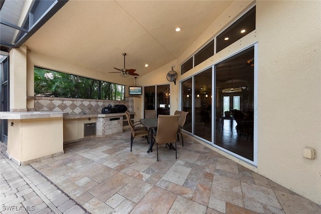 view of patio with an outdoor kitchen and ceiling fan