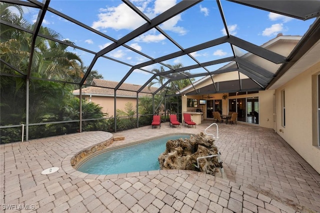 view of swimming pool with an outdoor bar, a lanai, and a patio area