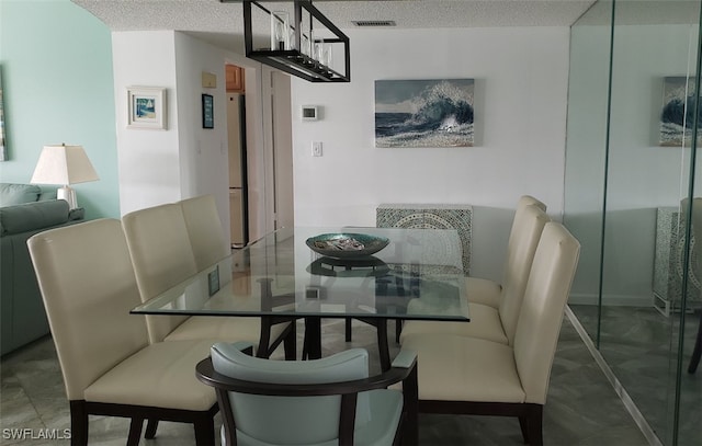 dining room with a textured ceiling