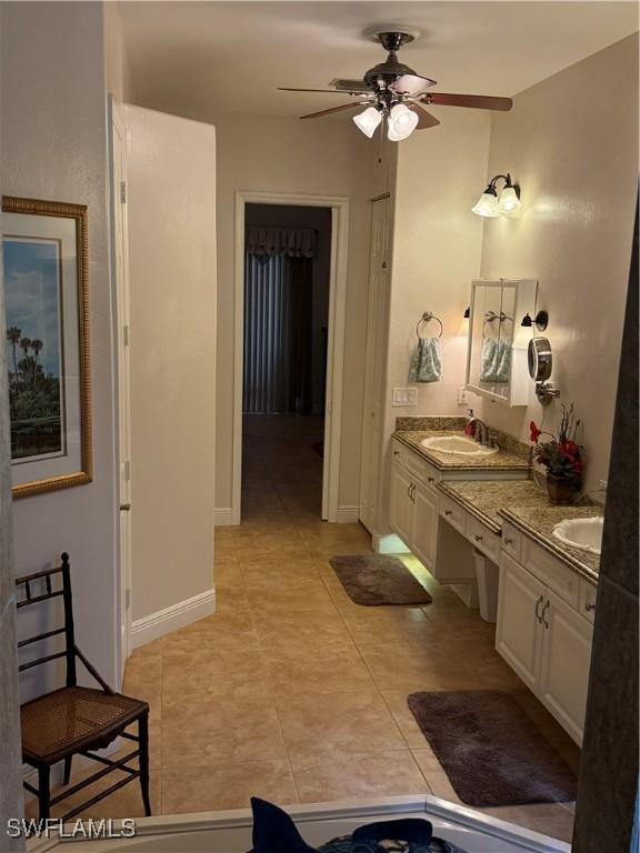 bathroom featuring ceiling fan, tile patterned flooring, and vanity