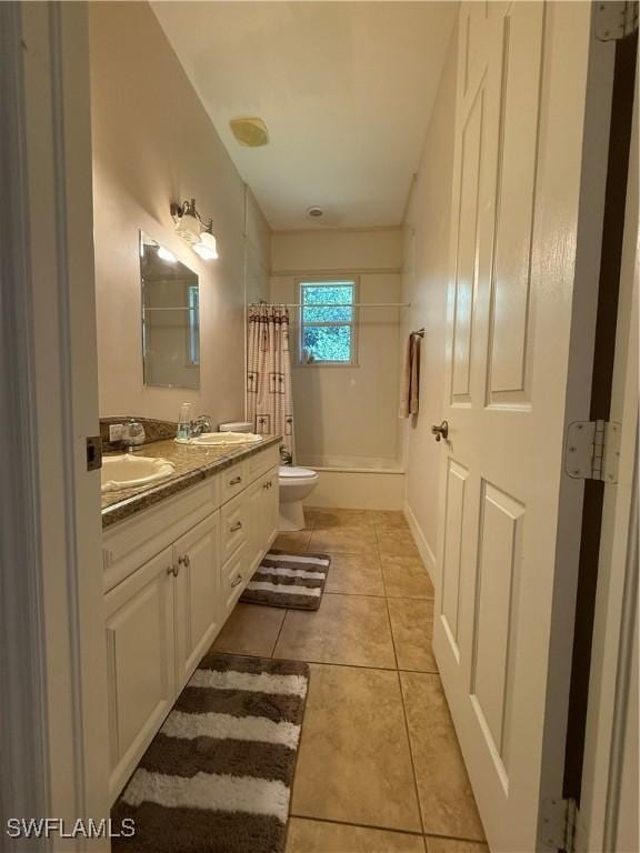 full bathroom with tile patterned flooring, shower / bath combination with curtain, vanity, and toilet