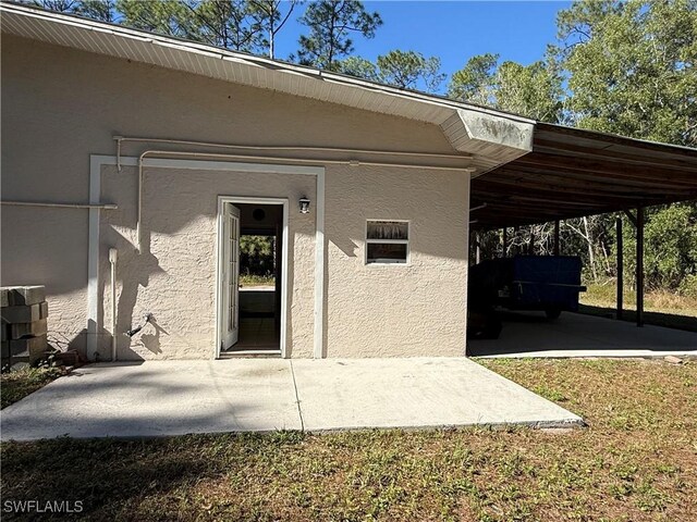 property entrance featuring a carport