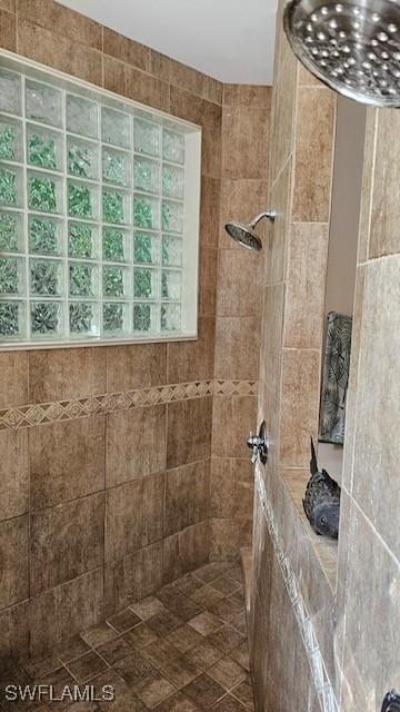 bathroom with a tile shower