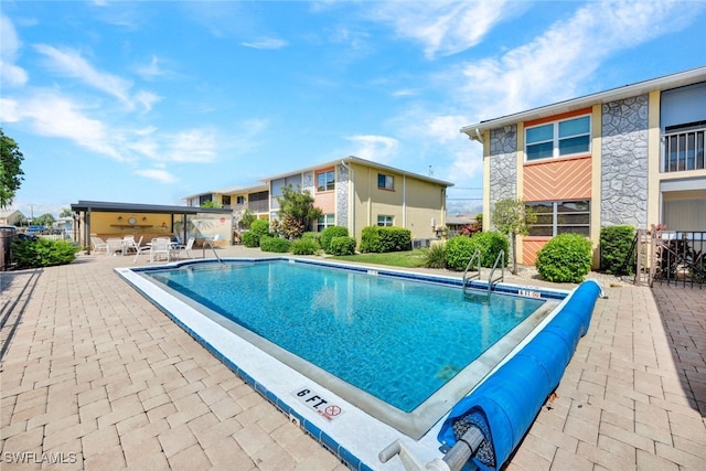 view of swimming pool with a patio