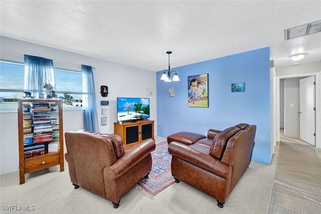 living room with light carpet and a chandelier