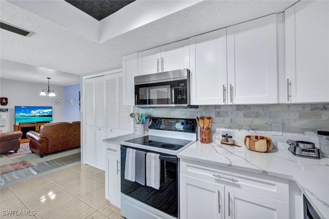 kitchen featuring pendant lighting, white cabinets, an inviting chandelier, white electric range oven, and light tile patterned floors