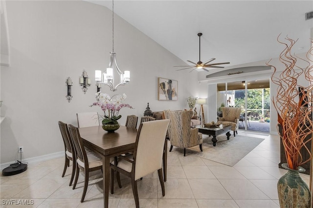 dining area with light tile patterned floors, ceiling fan with notable chandelier, and vaulted ceiling