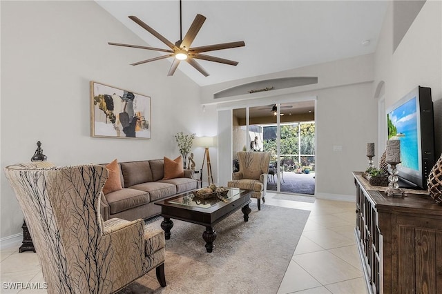 living room featuring ceiling fan, light tile patterned floors, and lofted ceiling