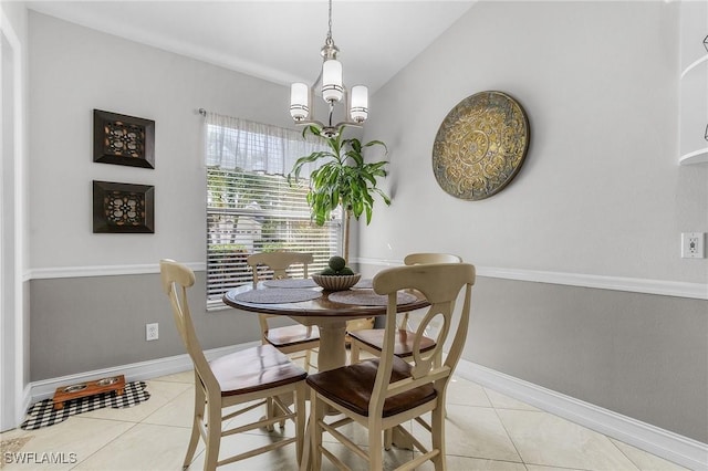 tiled dining room featuring vaulted ceiling and a notable chandelier