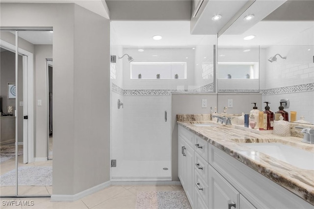 bathroom with vanity, a shower with shower door, and tile patterned flooring