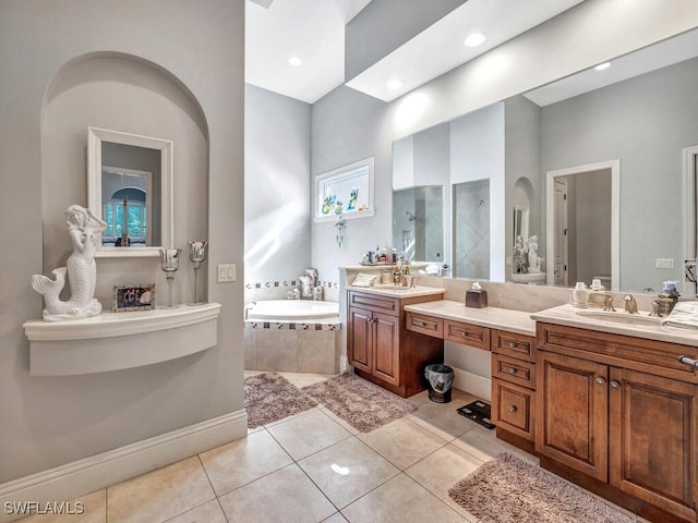 bathroom featuring tile patterned flooring, vanity, and plus walk in shower