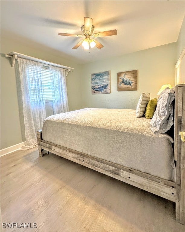 bedroom with ceiling fan and light hardwood / wood-style floors