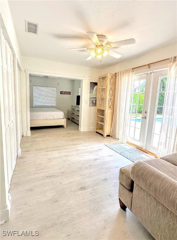 bedroom featuring access to exterior, ceiling fan, and light hardwood / wood-style floors