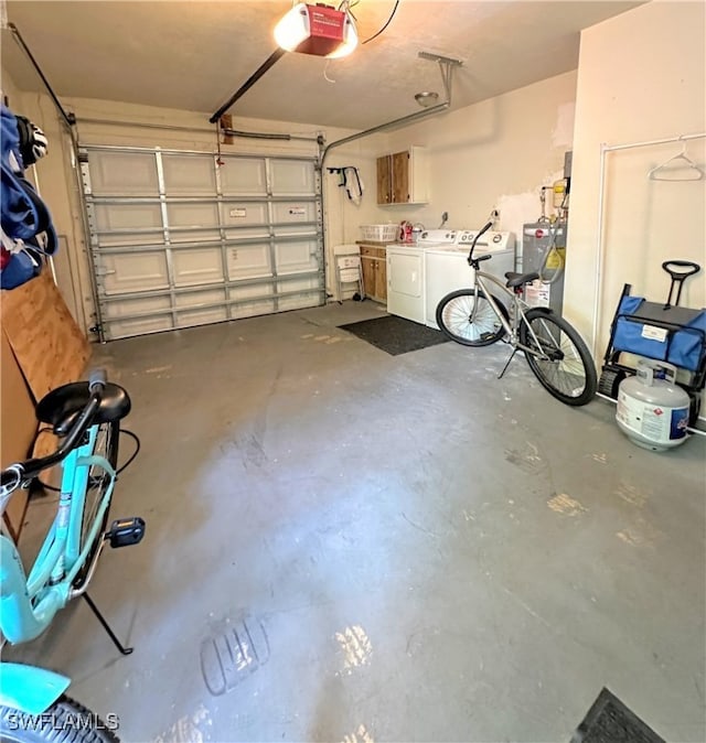 garage featuring a garage door opener, water heater, and separate washer and dryer