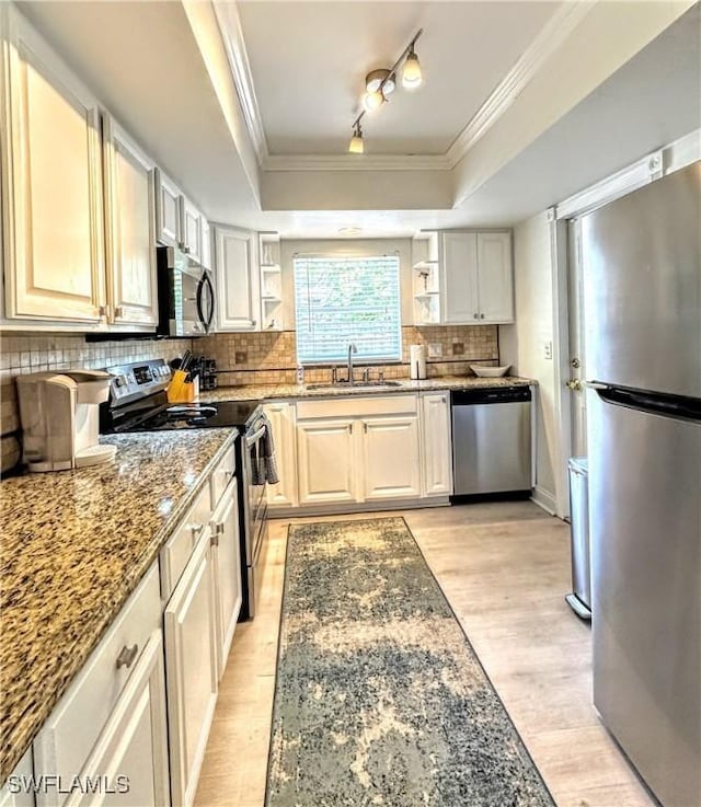 856 98th Ave N, Naples, FL 34108 - kitchen featuring stainless steel appliances, open shelves, crown molding, stone counters, and light wood-style floors