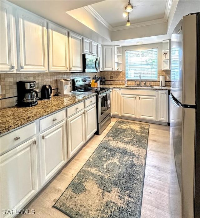 856 98th Ave N, Naples, FL 34108 - kitchen featuring appliances with stainless steel finishes, a raised ceiling, open shelves, crown molding, and decorative backsplash