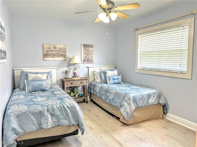 bedroom featuring hardwood / wood-style flooring and ceiling fan