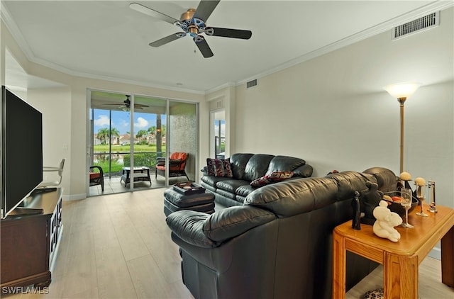 living room featuring ornamental molding, light wood-type flooring, and ceiling fan