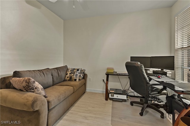 office space with light wood-type flooring and ceiling fan