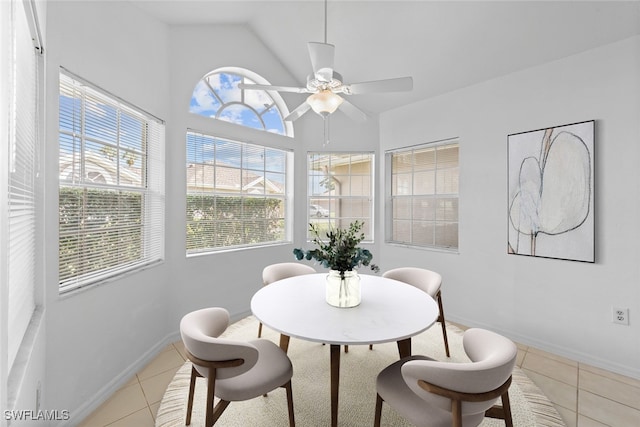 dining room with vaulted ceiling, ceiling fan, and light tile patterned floors