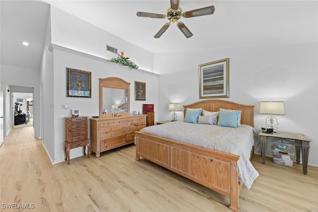 bedroom featuring high vaulted ceiling, ceiling fan, and light wood-type flooring