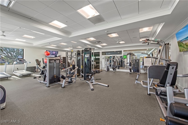 exercise room with a drop ceiling and ceiling fan