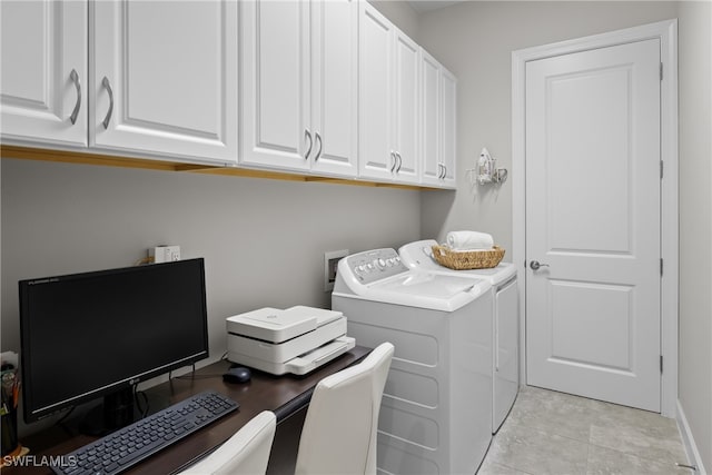 laundry room featuring cabinets, light tile patterned flooring, and washing machine and clothes dryer