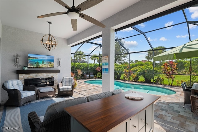 exterior space featuring ceiling fan, glass enclosure, and a patio area