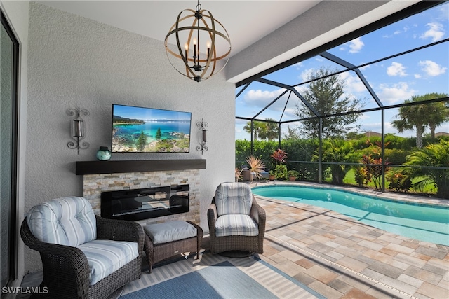 view of pool with a patio area and a lanai