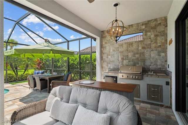 view of patio / terrace with sink, area for grilling, grilling area, and a lanai