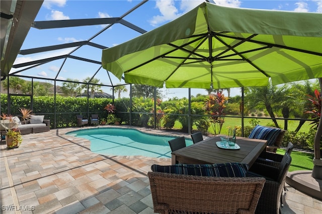 view of swimming pool featuring a patio area and a lanai