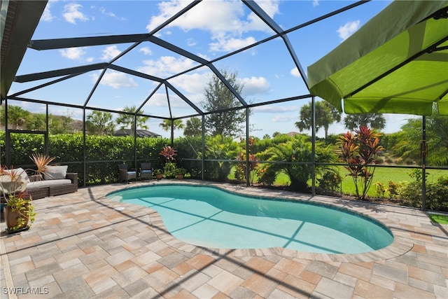 view of swimming pool featuring a patio and a lanai