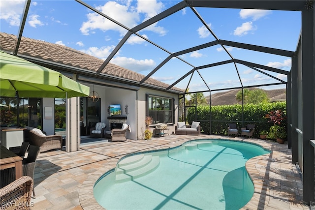 view of swimming pool with a patio, an outdoor living space, and glass enclosure