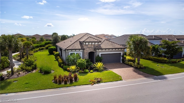 mediterranean / spanish home with a front yard and a garage