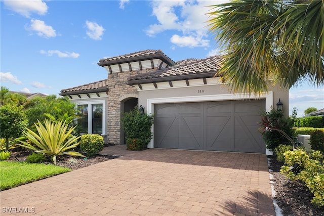 mediterranean / spanish house with a garage