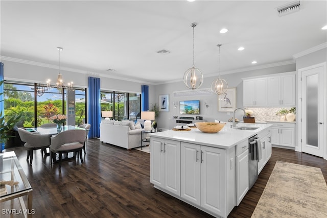 kitchen featuring dark wood-type flooring, white cabinets, sink, and a center island with sink