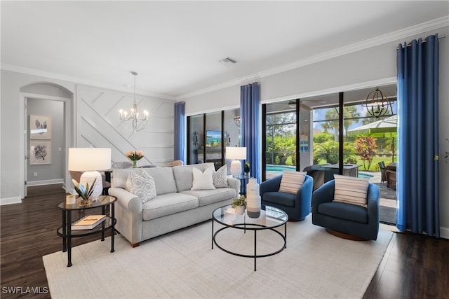 living room with ornamental molding, hardwood / wood-style flooring, and an inviting chandelier