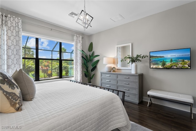 bedroom featuring hardwood / wood-style floors and a notable chandelier