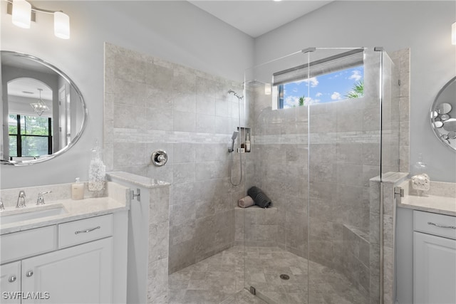 bathroom with vanity and tiled shower