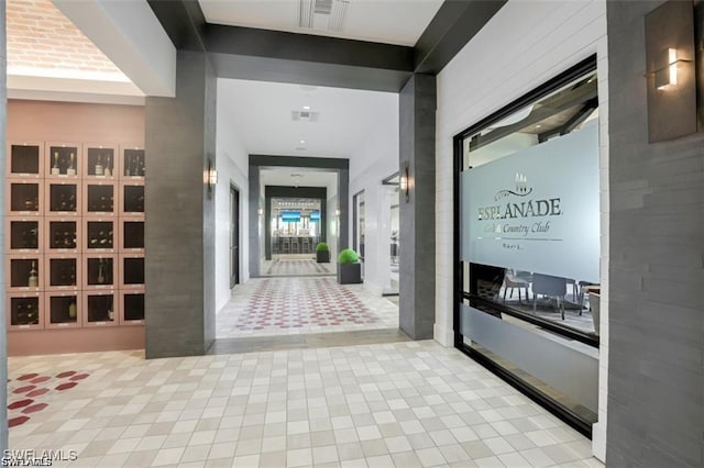 hall featuring light tile patterned floors