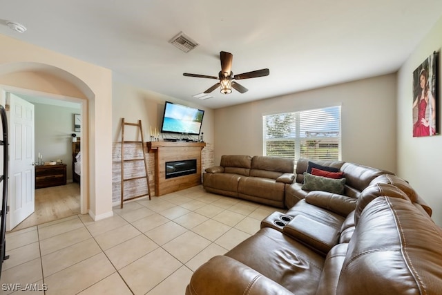 tiled living room with ceiling fan