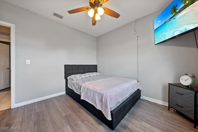 bedroom with ceiling fan and hardwood / wood-style floors